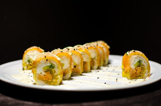 Sushi rolls in white plate and dark background