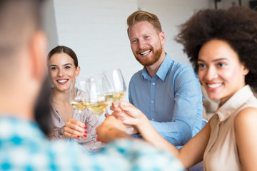 Happy friends toasting with wine.