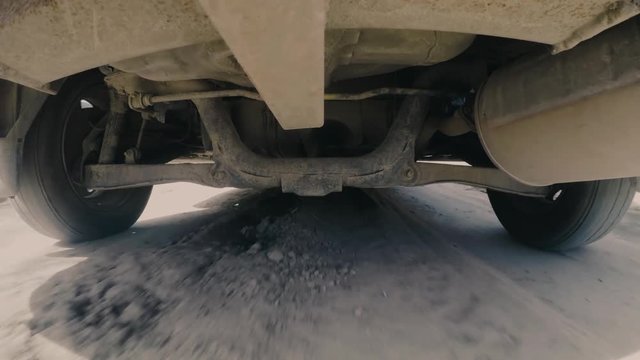 Car rides along the country off-road. travel concept. Camera mounted below of automobile and shows point of view tires and suspension use while driving. Dangerous.