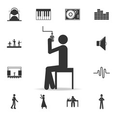 Singer sitting with microphone icon. Detailed set of music icons. Premium quality graphic design. One of the collection icons for websites; web design; mobile app