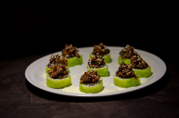 Sushi rolls in white plate and dark background