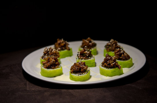 Sushi rolls in white plate and dark background