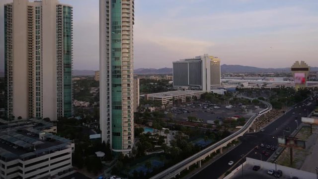 A day to night timelapse of the Las Vegas landscape. Hotels and residential buildings in the foreground.

