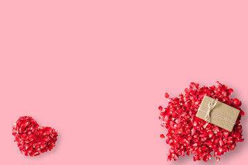 Rose petals and gift box on pink background