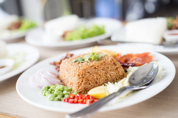 Salty brown fried Thai fried rice with assorted sweet pork and vegetable
