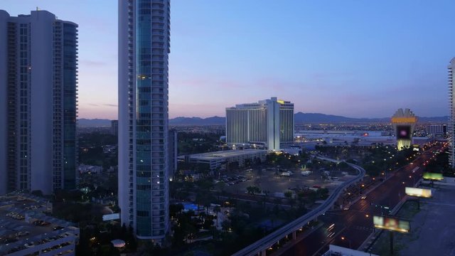 A night to day time lapse of the Las Vegas landscape. Hotels and residential buildings in the foreground.
