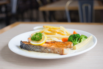 Salmon slice steak with yellow lemon decorated and vegetable, Fish &  chip