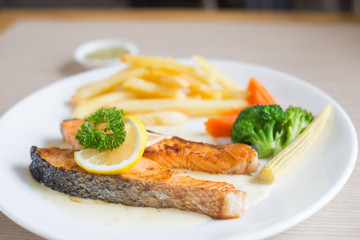 Salmon slice steak with yellow lemon decorated and vegetable, Fish &  chip