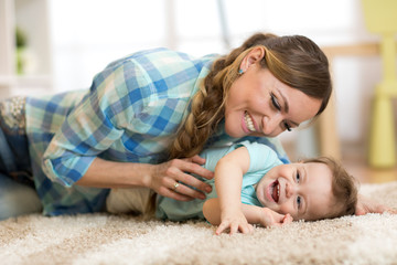 Mother with baby having a fun pastime at home