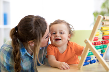 mother and baby son playing with abacus, early education