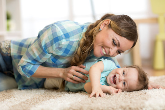 Mother with baby having a fun pastime at home