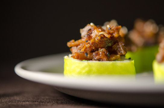 Sushi rolls in white plate and dark background