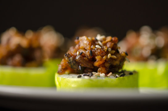 Sushi rolls in white plate and dark background