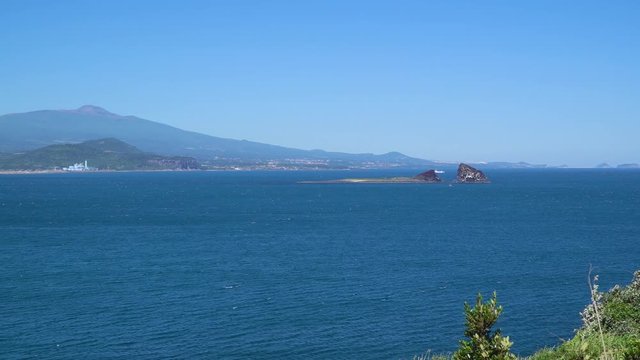 Landscape of Sagye-ri village and southwestern coast of Jeju Island with Sanbangsan and Hallasan mountain, viewed from Olle trail No.10 at Songaksan mountain.