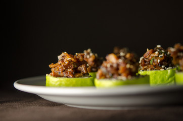 Sushi rolls in white plate and dark background