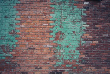 red brick wall with turquoise paint