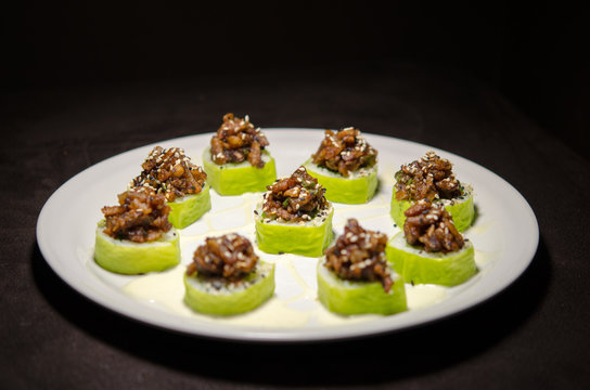 Sushi rolls in white plate and dark background