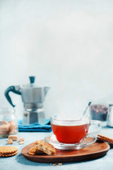 Cup of coffee with a Moka pot on a light concrete background. Morning coffee with cookies concept with copy space