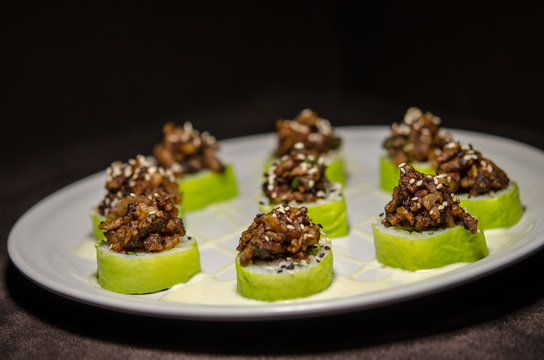 Sushi rolls in white plate and dark background