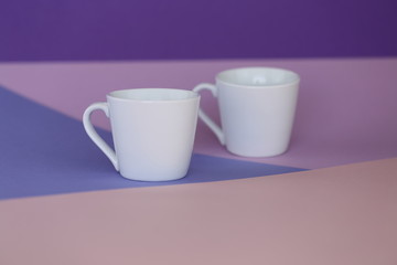 tableware mockup. Minimalist cup Mockup. white cups on a trendy graphic background .white cup on trend lilac pink  geometric background. copy space