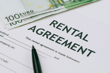 Obraz premium Pen and Euro banknotes money on rental agreement form document, ready to sign contract, property or real estate concept