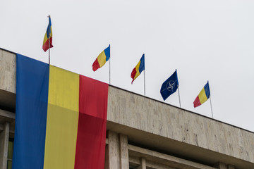 Romanian and NATO flags in the wind
