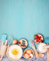 Photo sur Plexiglas Cuisinier Ustensiles de cuisson et ingrédients de cuisson pour tartes, biscuits, pâte et pâtisserie. Mise à plat avec œufs, farine, sucre, baies. Vue de dessus, maquette de recette, cours de cuisine, blog de cuisine.