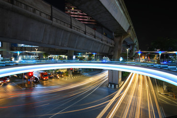 Fototapeta na wymiar Bangkok,Thailand - 31 October 2017 : Night light with long speed shutter of traffic at MBK, BTS Siam interchange in front of Siam Discovery and Art Museum junction on Halloween night