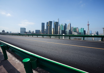 Empty road surface floor with city landmark buildings of Shanghai Skyline