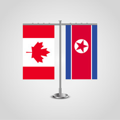 Table stand with flags of Canada and North Korea.Two flag. Flag pole. Symbolizing the cooperation between the two countries. Table flags