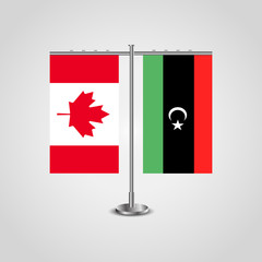 Table stand with flags of Canada and Libya.Two flag. Flag pole. Symbolizing the cooperation between the two countries. Table flags