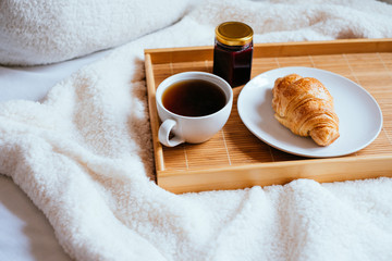 Coffee and croissant in bed