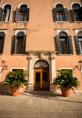 Fototapeta na wymiar Ancient Facade with Wooden Vintage Door and Windows in Venice.