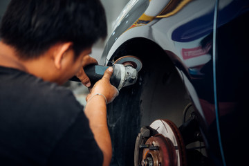 Checking car fiber bumper body part at car garage