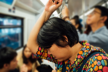 Asian woman travel on skytrain train in city