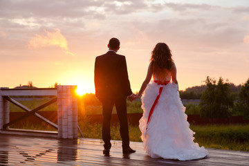 the couple looks at the evening sun