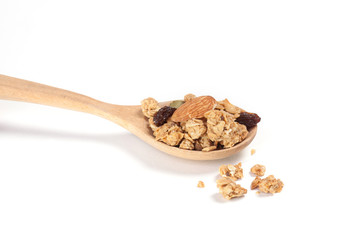 Close up Granola, Currant, Almond and Sunflower Seed on the wooden spoon isolated on white background.