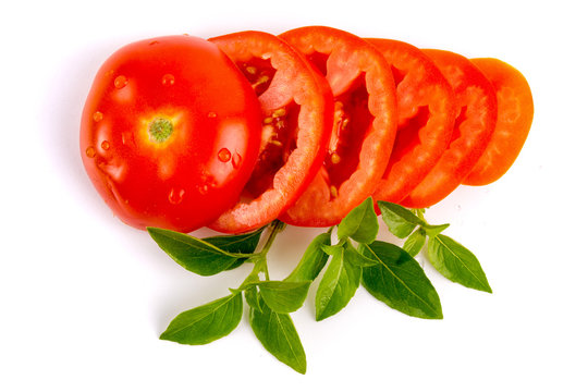 Tomatos slides with herbs isolated on white background, top view