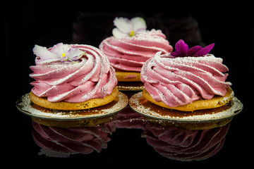 three pink zephyr cookies on black background