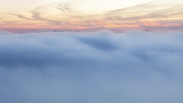 Sunset over clouds mist in mountain landcape at sunrise, Time lapse, Slovakia