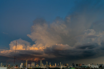 Naklejka na ściany i meble storm clouds above bangkok city with beautiful sunset light