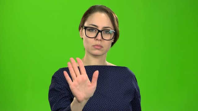 Director woman shows a stop to her subordinates. Green screen