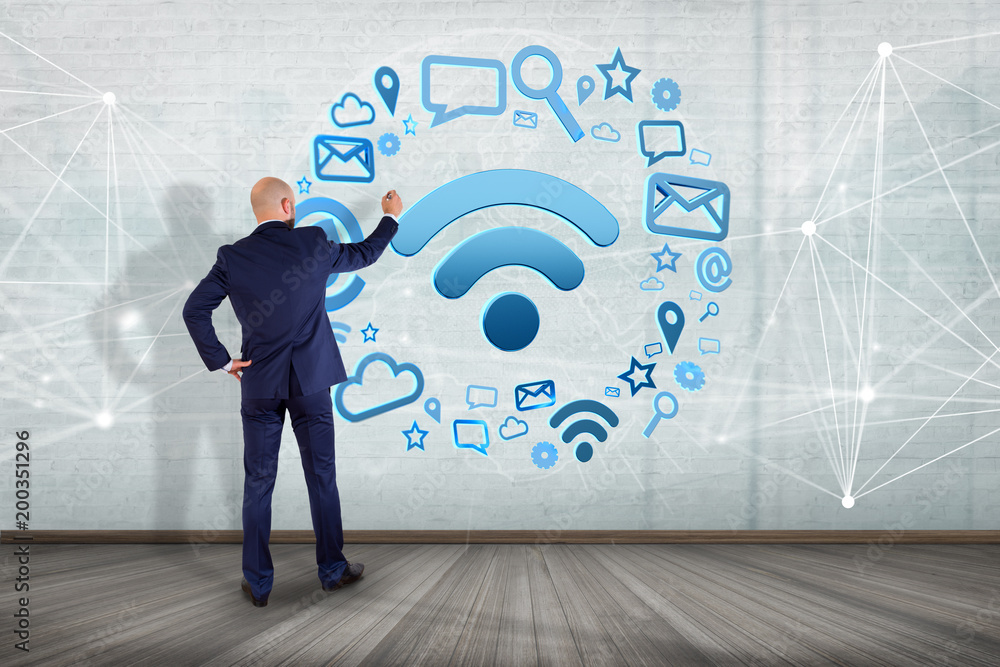 Poster businessman in front of a wall with wifi symbol connection surrounded by multimedia and internet app