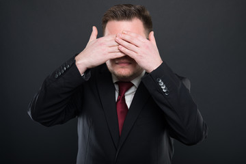 Business man making covering eyes like blind concept.
