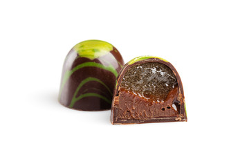 Cut luxury handmade bonbon with chocolate ganache and fruit jelly filling isolated on white...