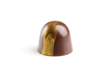 Handmade chocolate candy decorated with golden paint isolated on white background