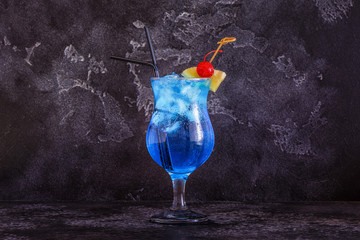 Blue Curacao cocktail decorated with fruit. - obrazy, fototapety, plakaty