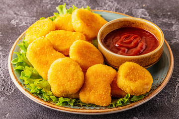 Chicken breast nuggets with sauces.