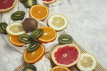 Fresh Fruits on a Light Stone Background. Copy space and a top view