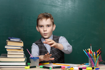 The pupil mades magical passes against the background of the green board